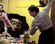 Harvey Brenton serves tea over his shoulder using long necked teapot.