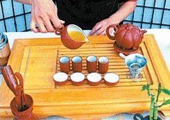 Filling the snifter cups with tea.