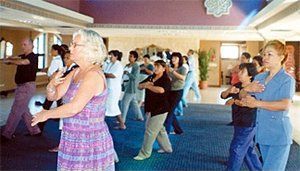 Pamela Brady leads a qigong session from last year's meeting.