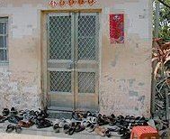 Patients' shoes piled outside the door to Dr. Fuda's clinic.