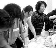 Aileen Huang leads attendees in a dumpling-making demonstration.